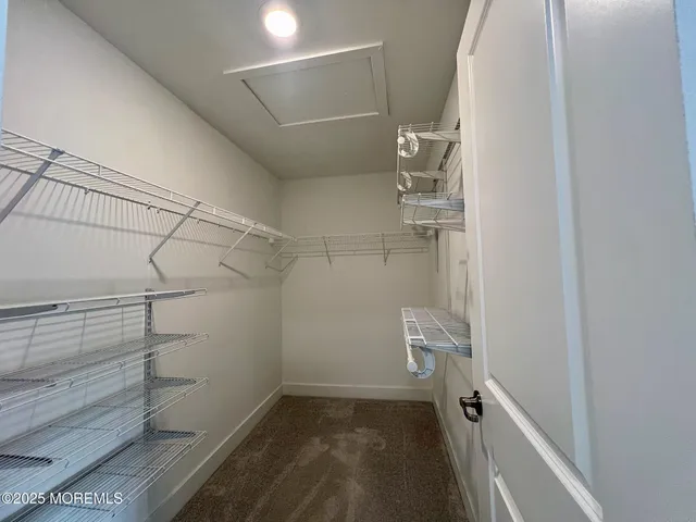 a view of walk in closet with empty racks