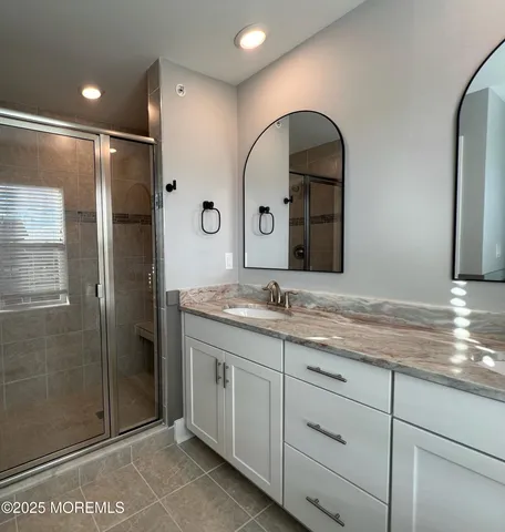 a bathroom with a double vanity sink and mirror