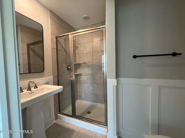 a bathroom with a tub a sink and mirror