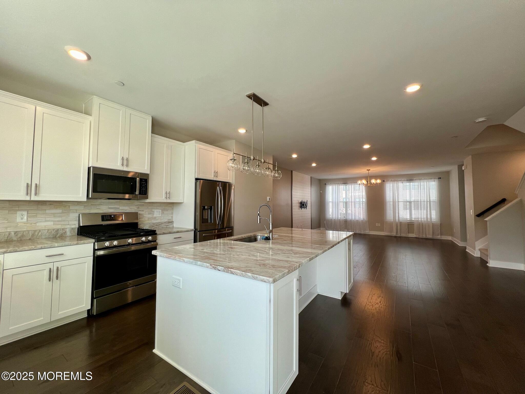 32 Mariveles Way Tinton Falls, NJ 07724 - Photo 5 of 28 a kitchen with a sink and microwave