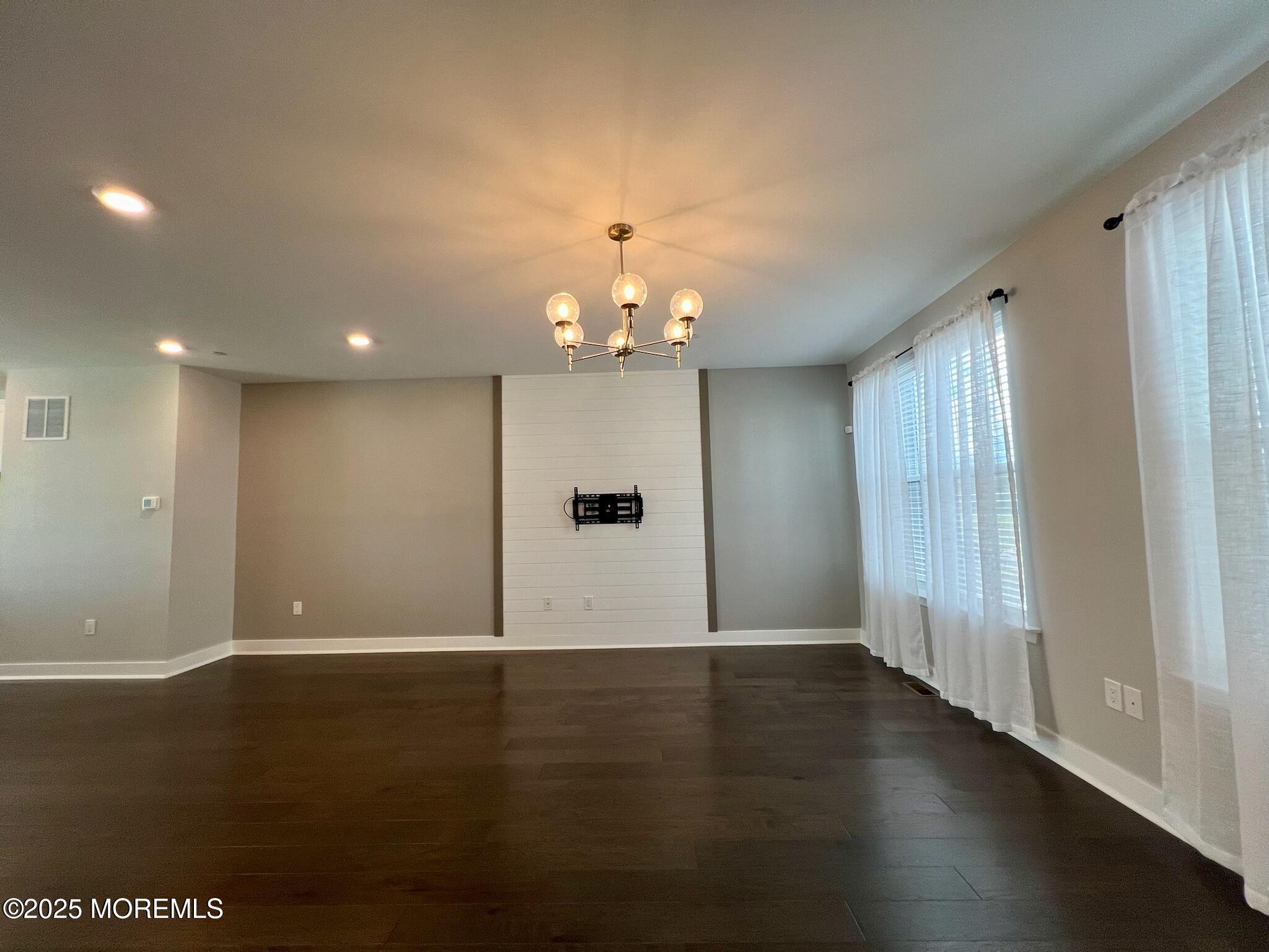32 Mariveles Way Tinton Falls, NJ 07724 - Photo 10 of 28 an empty room with wooden floor and windows