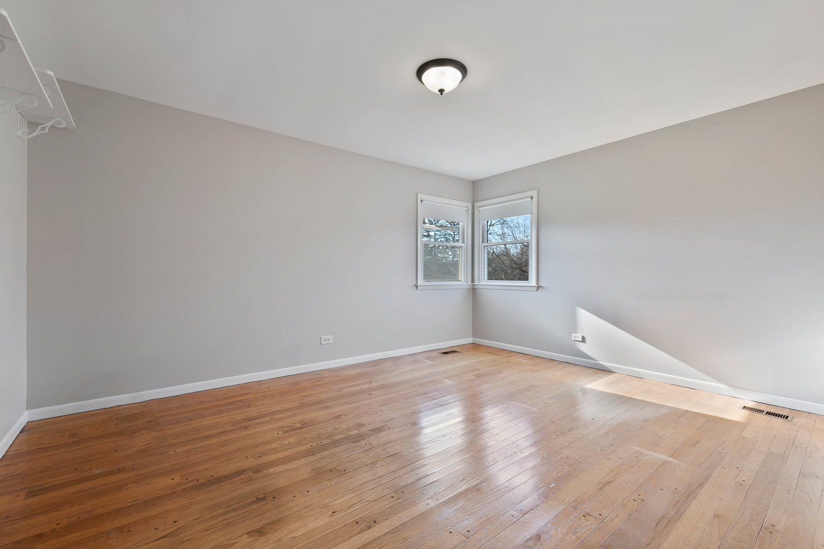 28W171 Garys Mill Road Winfield, IL 60190 - Photo 14 of 47 an empty room with wooden floor and windows