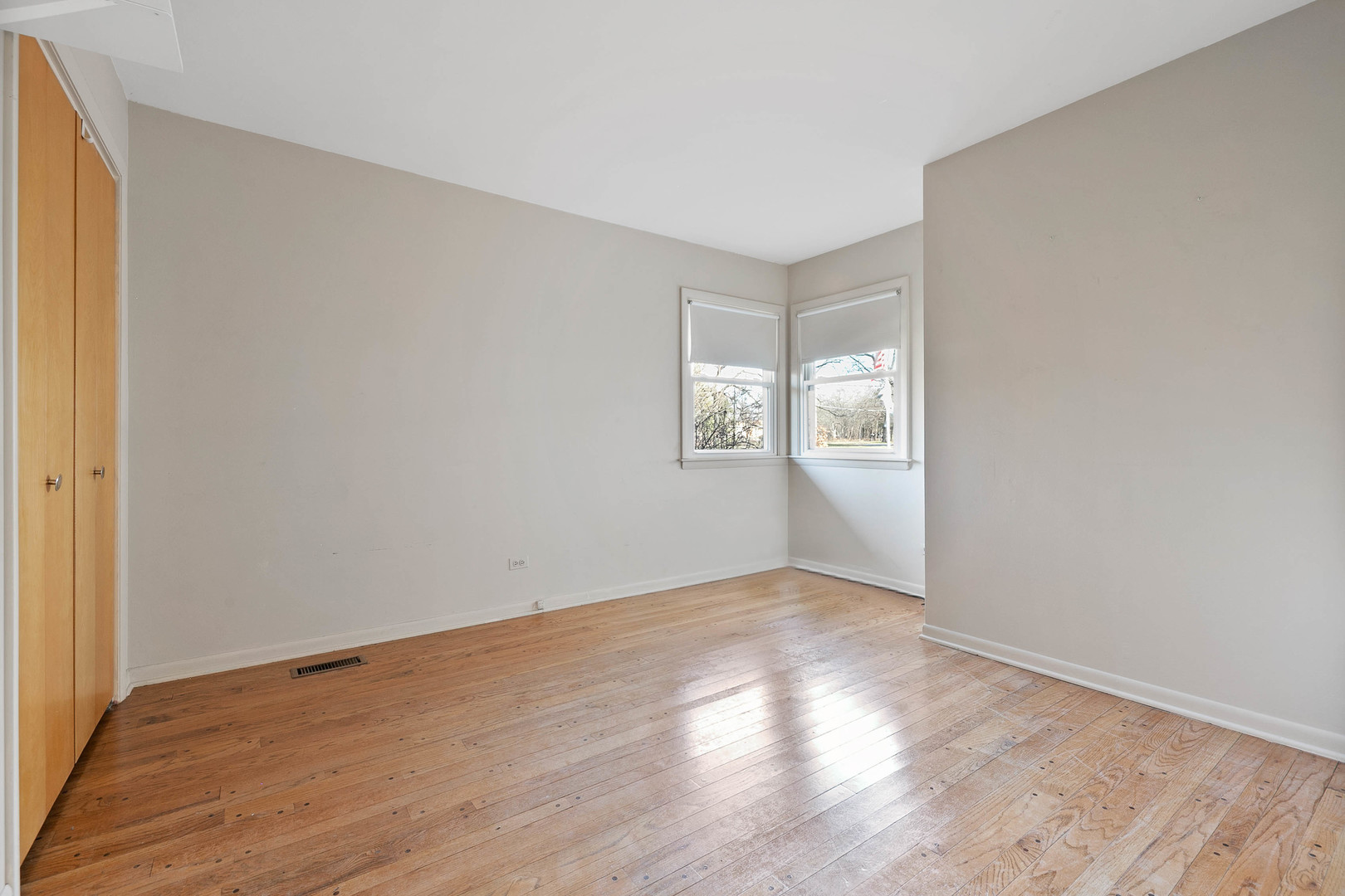 28W171 Garys Mill Road Winfield, IL 60190 - Photo 18 of 47 an empty room with wooden floor and windows