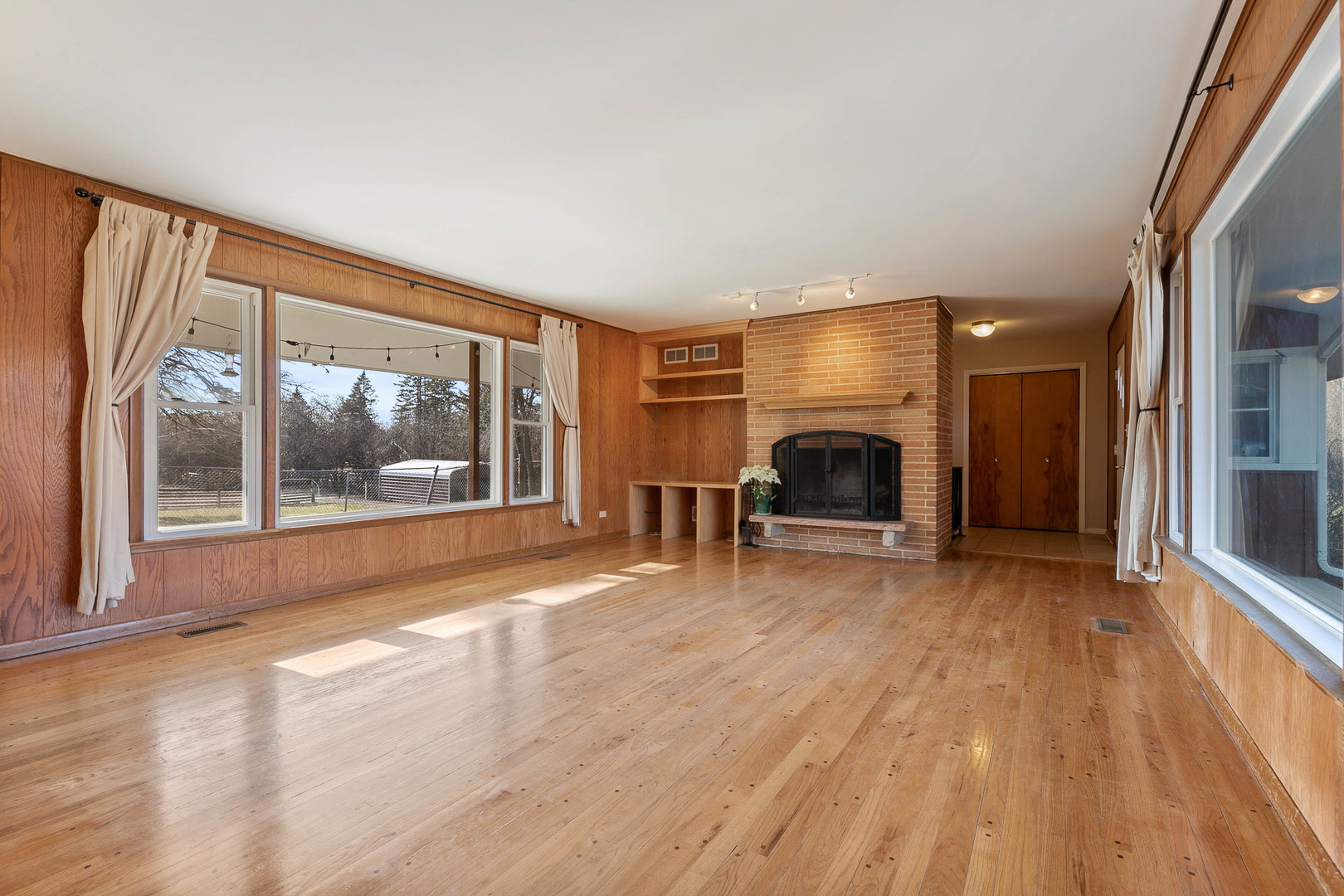 28W171 Garys Mill Road Winfield, IL 60190 - Photo 3 of 47 a view of a livingroom with wooden floor and a fireplace