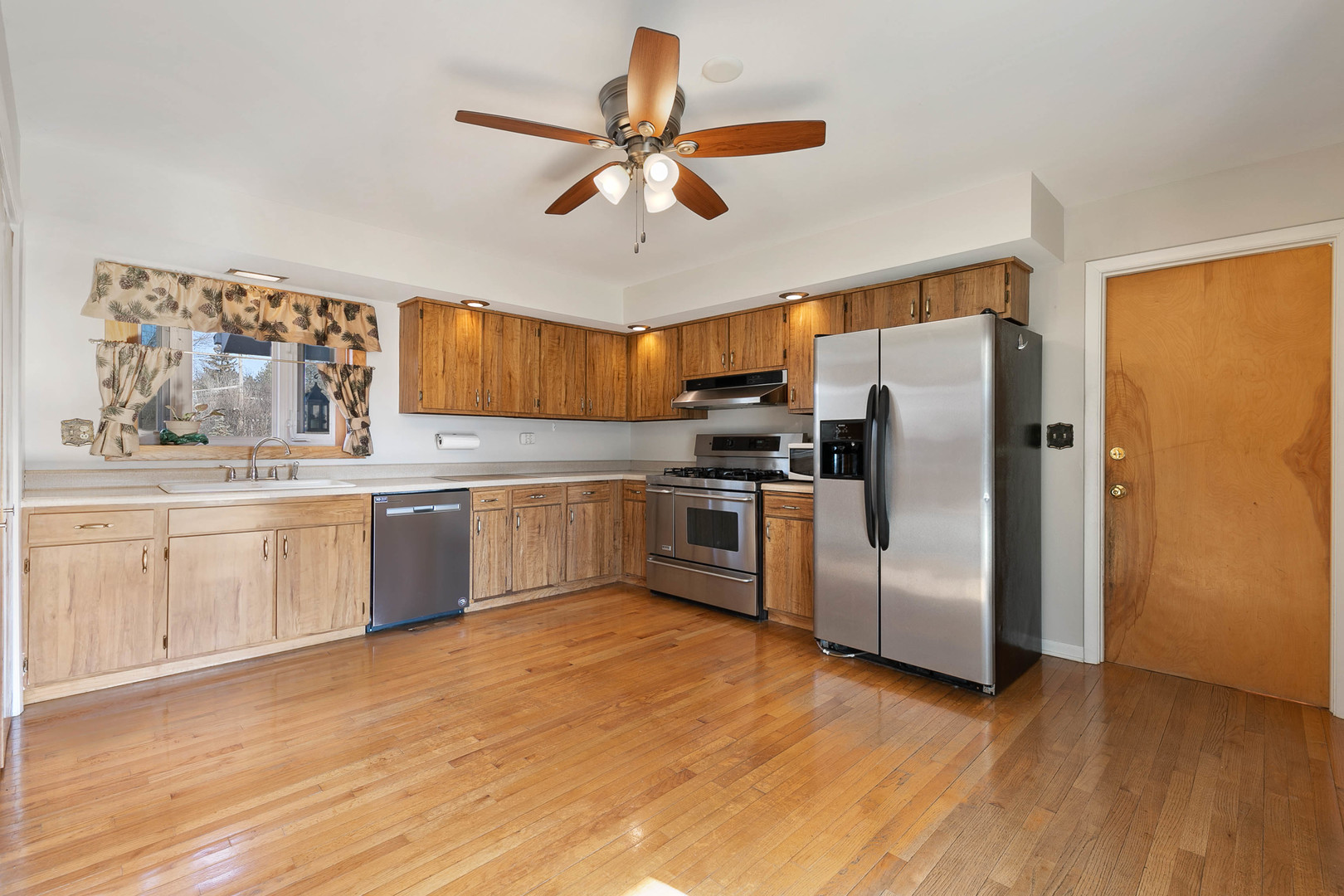28W171 Garys Mill Road Winfield, IL 60190 - Photo 7 of 47 a kitchen with stainless steel appliances a refrigerator a sink a stove a microwave and island
