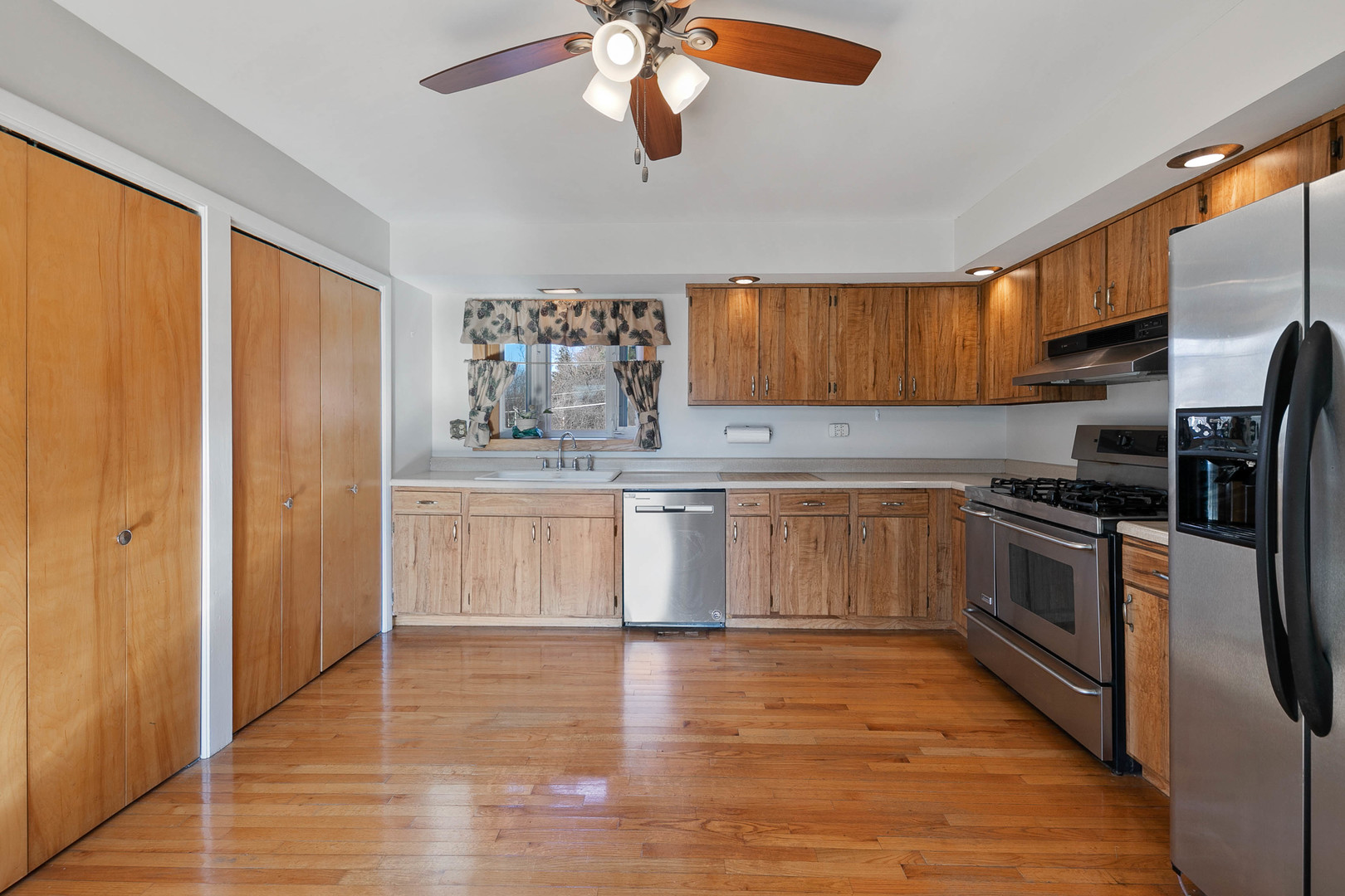 28W171 Garys Mill Road Winfield, IL 60190 - Photo 8 of 47 a kitchen with stainless steel appliances granite countertop a stove top oven a sink and a refrigerator