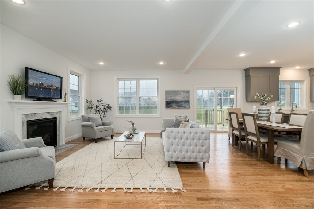 62 High Street, Unit LOT 1 Stoneham, MA 02180 - Photo 13 of 22 a living room with furniture fireplace and flat screen tv