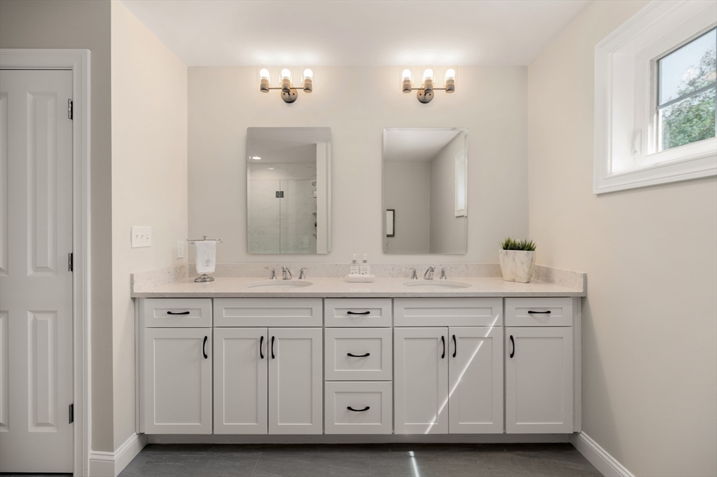 62 High Street, Unit LOT 1 Stoneham, MA 02180 - Photo 18 of 22 a bathroom with a granite countertop double vanity sink and a mirror
