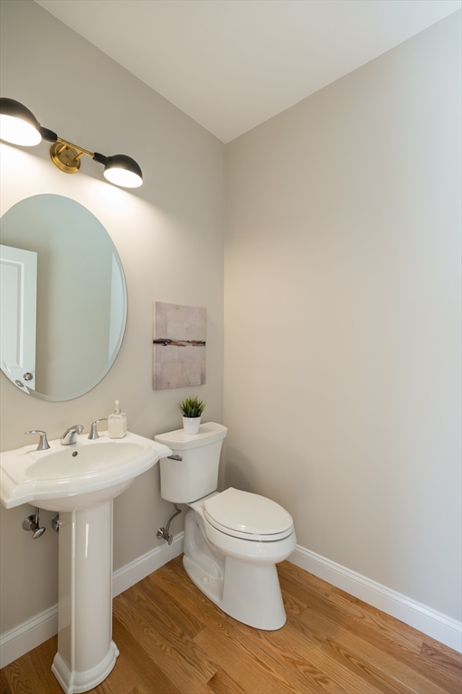62 High Street, Unit LOT 1 Stoneham, MA 02180 - Photo 19 of 22 a white toilet sitting next to a bathroom sink