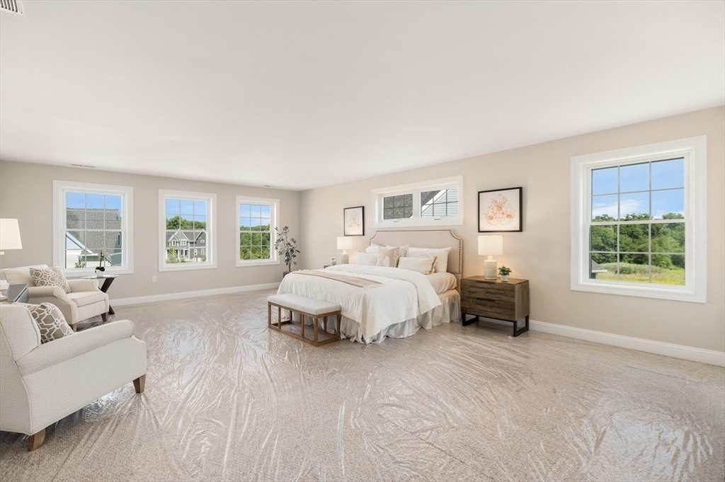 62 High Street, Unit LOT 1 Stoneham, MA 02180 - Photo 20 of 22 a spacious bedroom with a bed and a couch