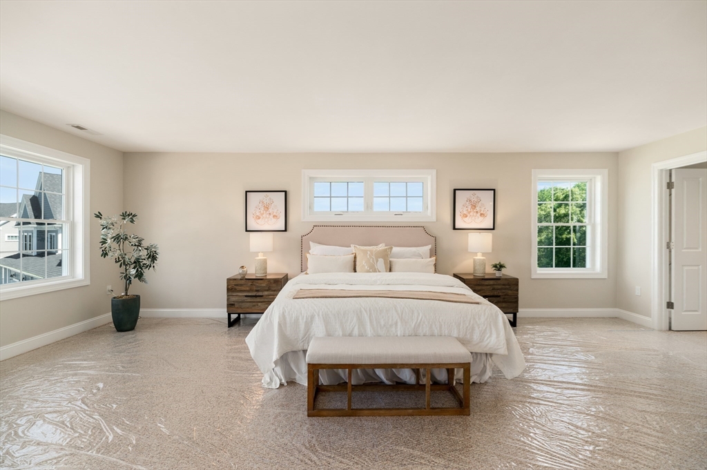 62 High Street, Unit LOT 1 Stoneham, MA 02180 - Photo 21 of 22 a spacious bedroom with a bed and a couch