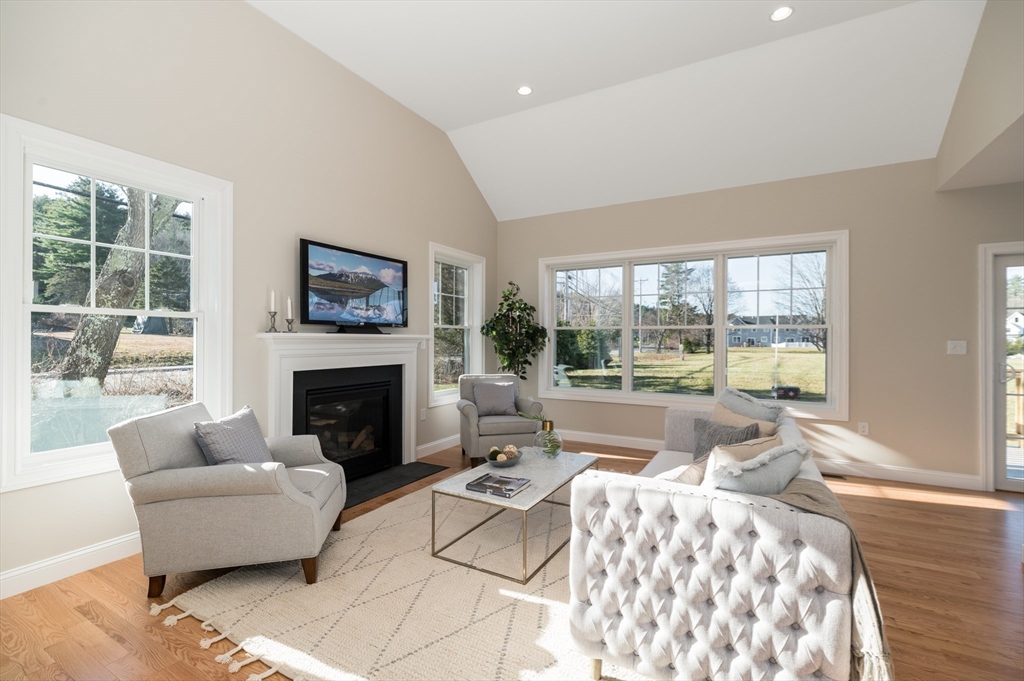 62 High Street, Unit LOT 1 Stoneham, MA 02180 - Photo 9 of 22 a living room with furniture fireplace and a large window