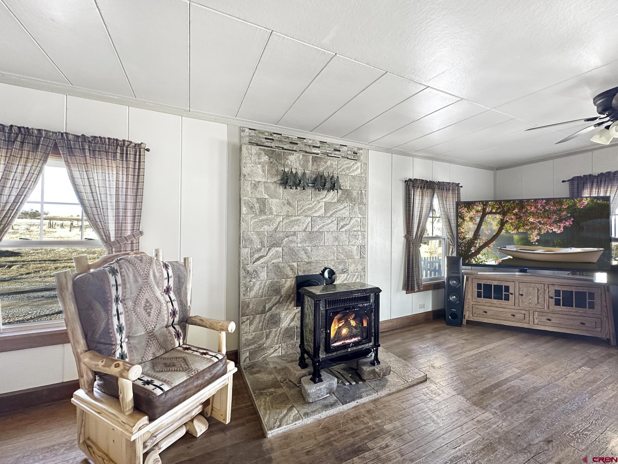 36024 Fruitland Mesa Road Crawford, CO 81415 - Photo 15 of 37 a living room with furniture and a fireplace