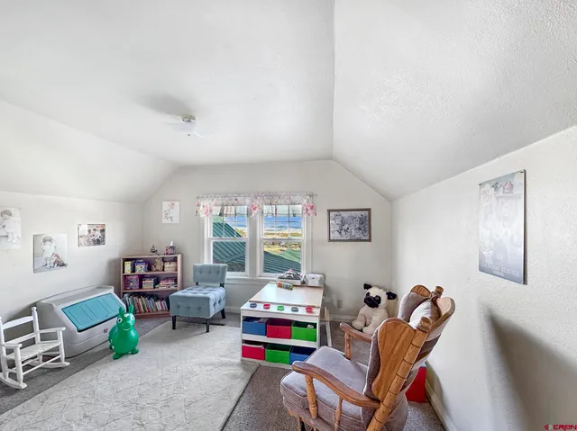 a view of lake with table and chairs