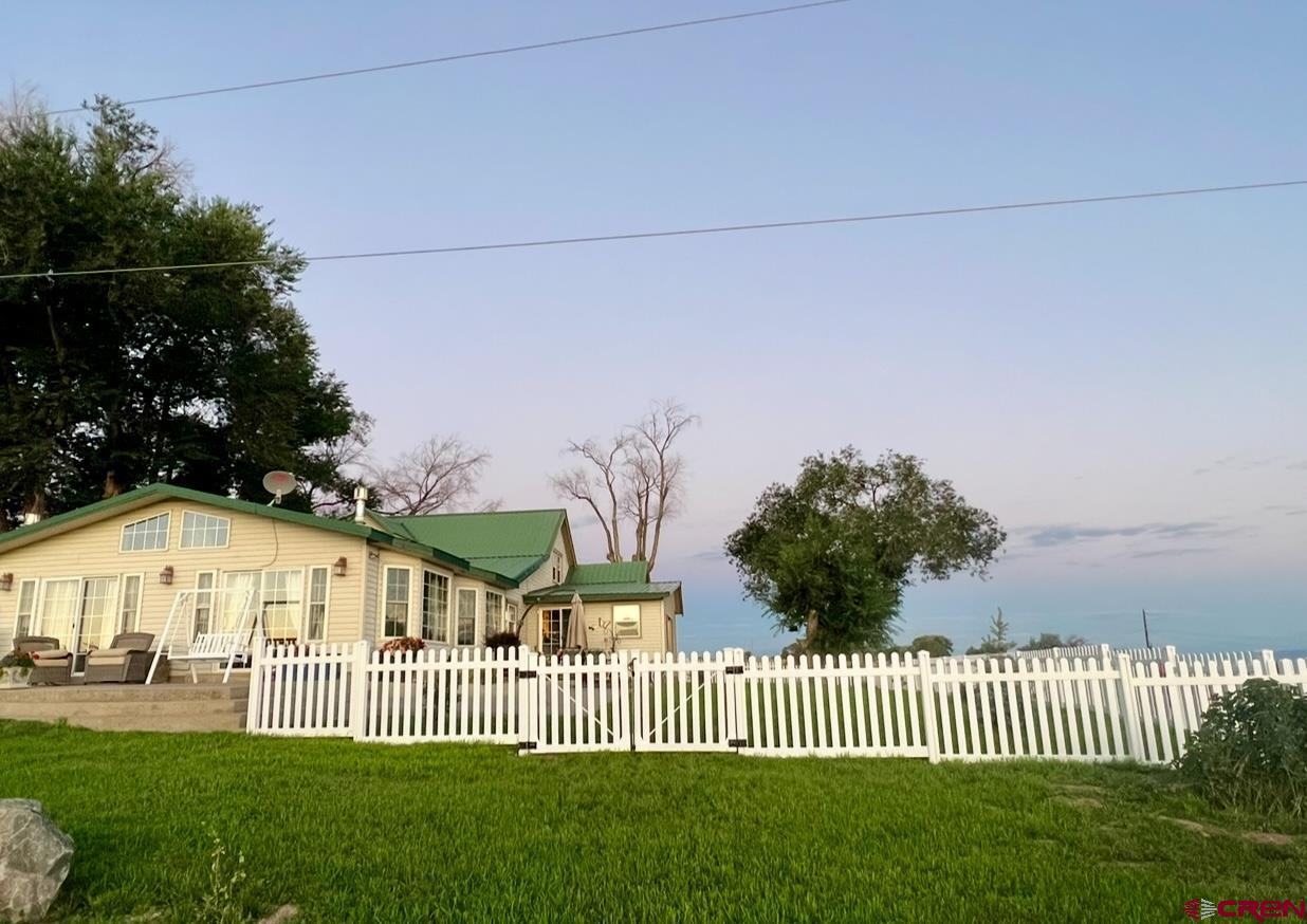 36024 Fruitland Mesa Road Crawford, CO 81415 - Photo 31 of 37 a view of a house with backyard and porch