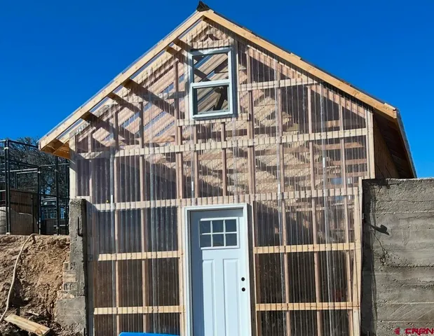 a front view of a house with patio and yard