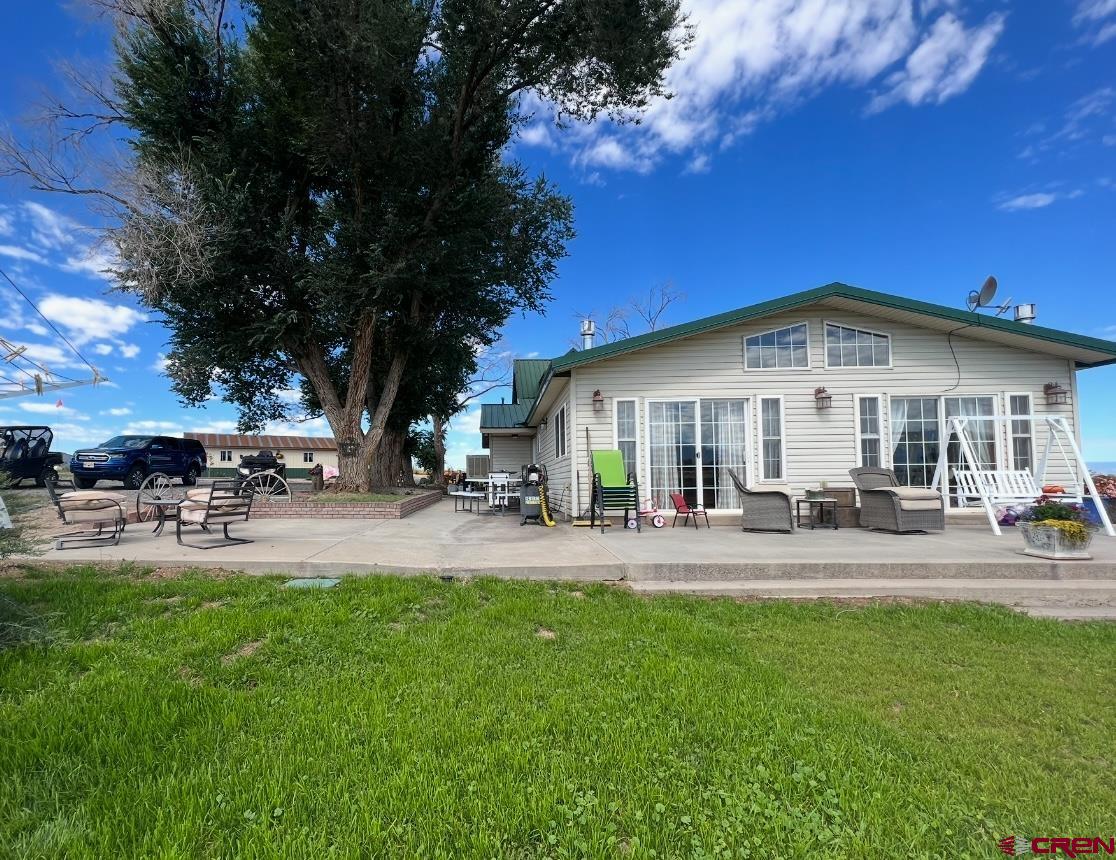 36024 Fruitland Mesa Road Crawford, CO 81415 - Photo 33 of 37 a front view of a house with patio and yard