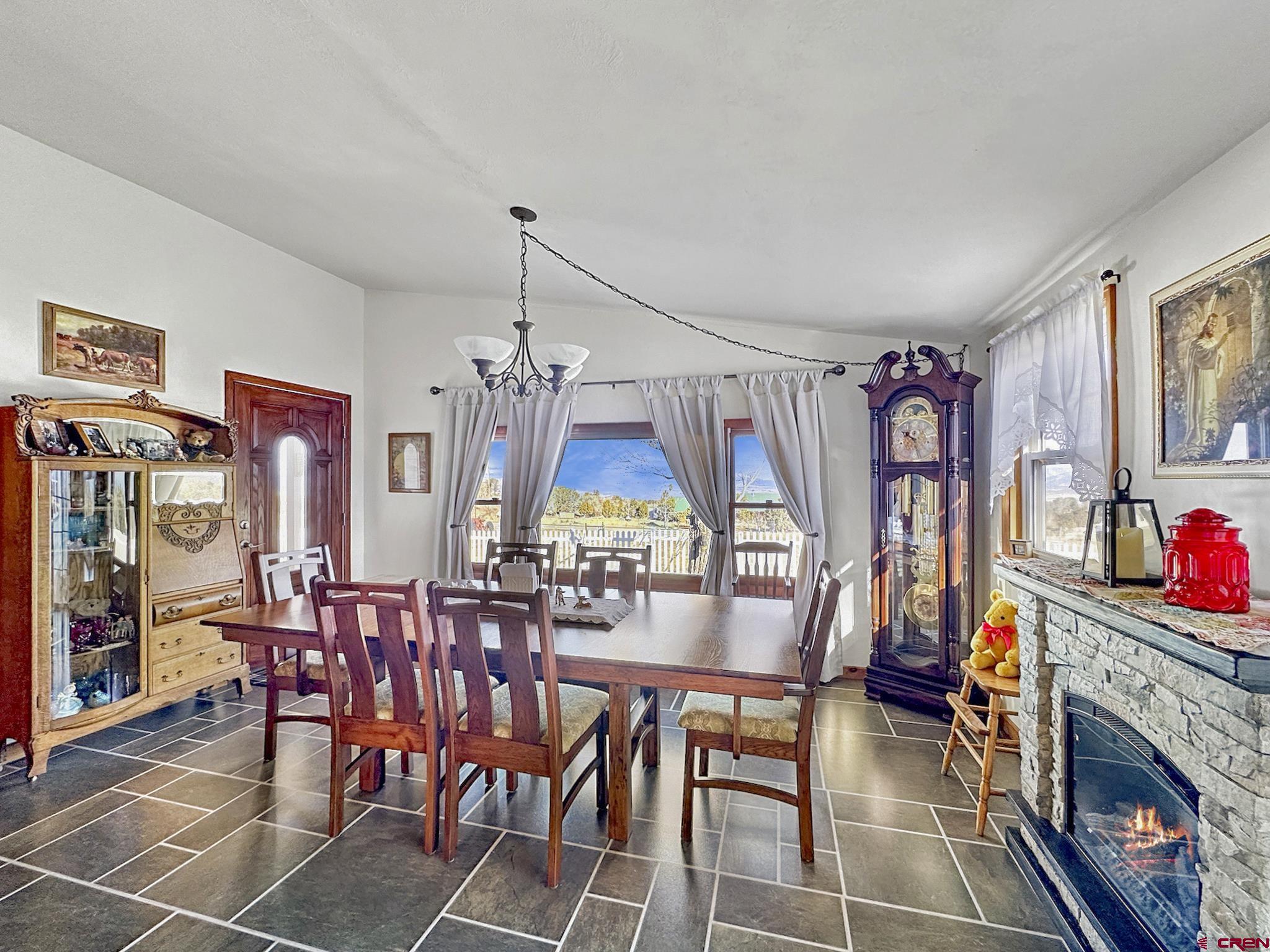 36024 Fruitland Mesa Road Crawford, CO 81415 - Photo 6 of 37 a view of a dining room with furniture wooden floor and chandelier