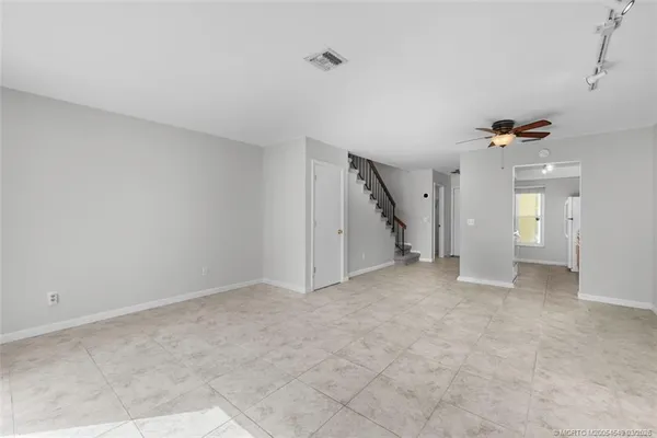 a view of a big room with closet and windows