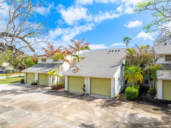 a view of a house with a yard and garage