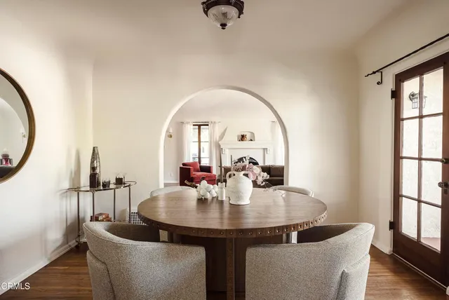 a living room with furniture and a mirror