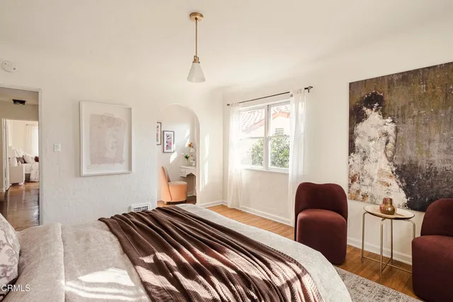 a bedroom with furniture and a window