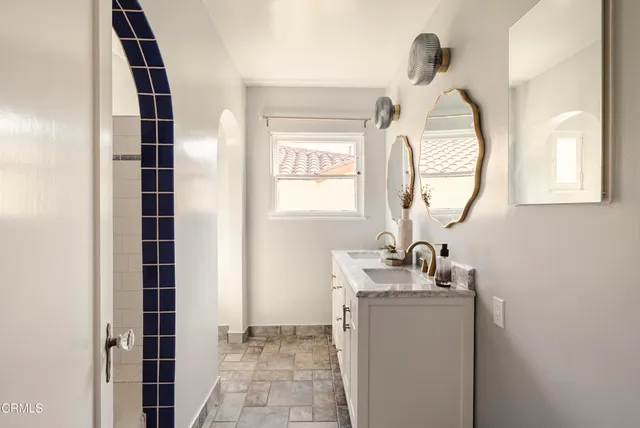 a bathroom with a sink a mirror and a shower