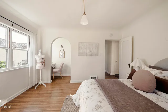 a bedroom with bed and window