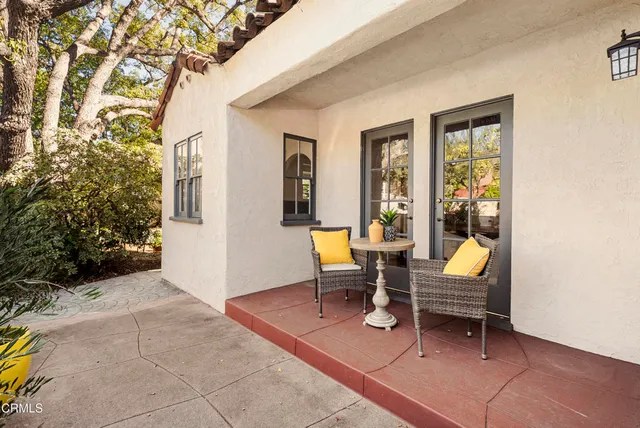 a view of a workspace with wooden floor and a potted plant
