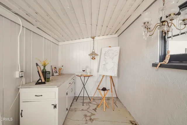 a view of a livingroom with wooden floor and white walls