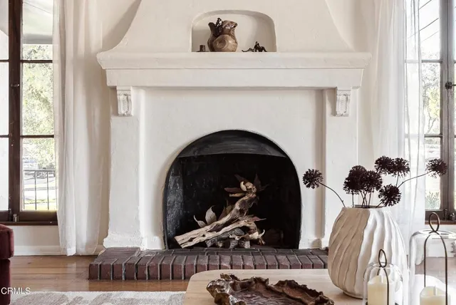 a view of a livingroom with a floor to ceiling window and a fireplace