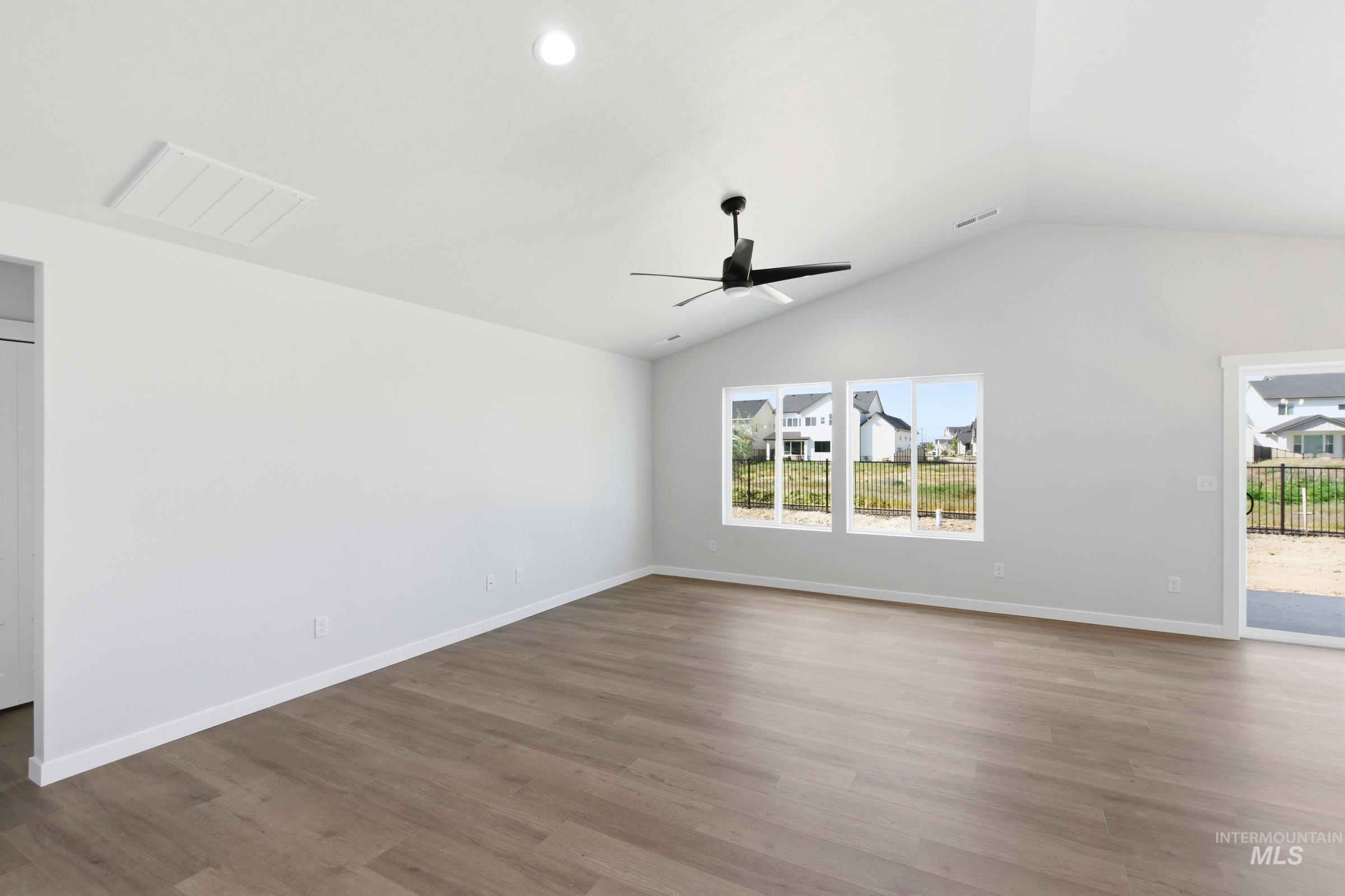 1059 West Jasper Street Meridian, ID 83642 - Photo 10 of 23 Spacious interior featuring wood-finish flooring, a vaulted ceiling, and a contemporary ceiling fan