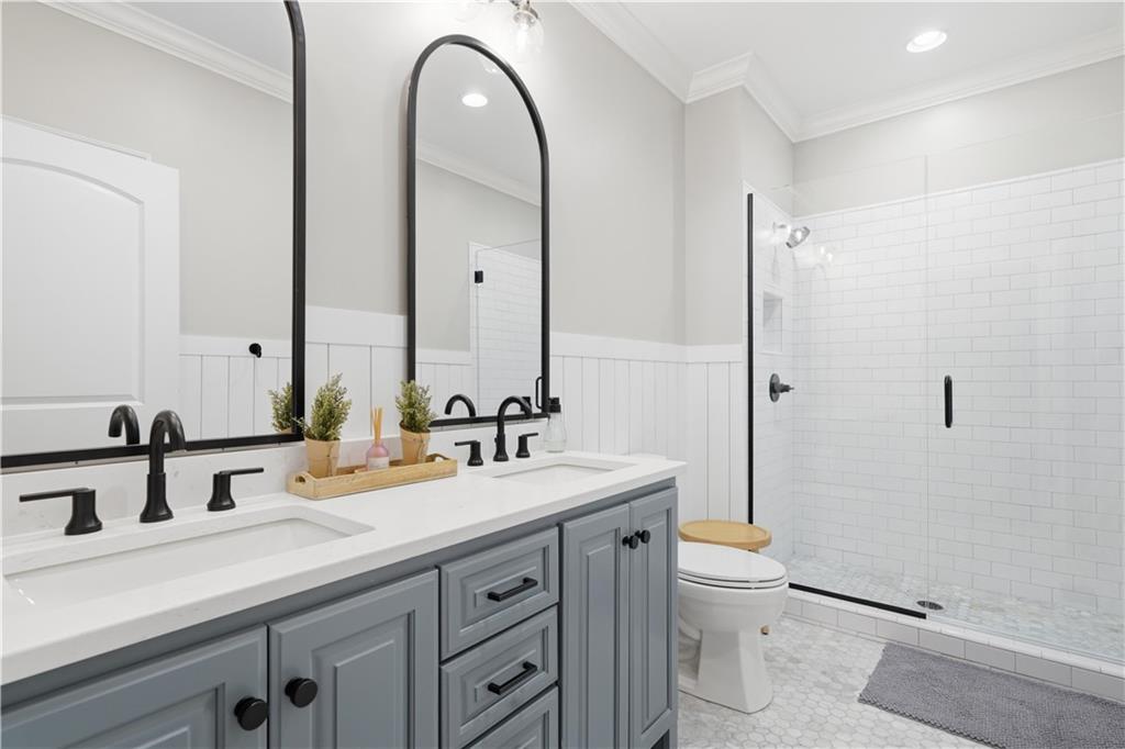 310 Gaines Road Southeast Dalton, GA 30721 - Photo 29 of 53 a spacious bathroom with a double vanity sink toilet mirror and a shower