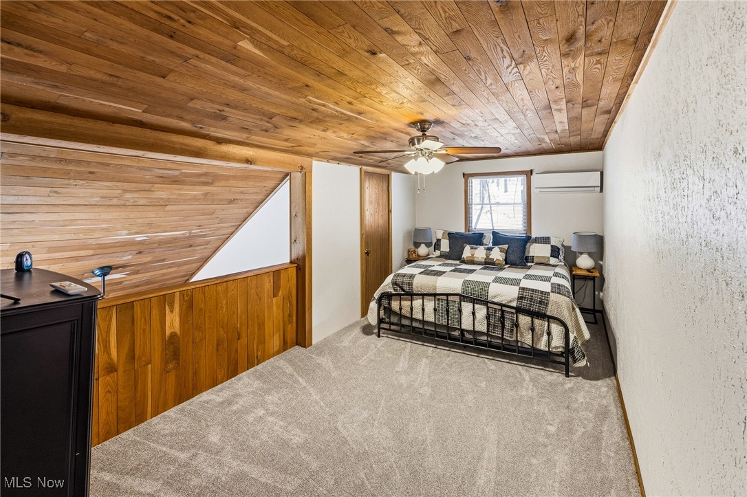 86523 North Bay Road Scio, OH 43988 - Photo 21 of 25 Bedroom with wood ceiling, carpet floors, ceiling fan, a wall unit AC, and wooden walls