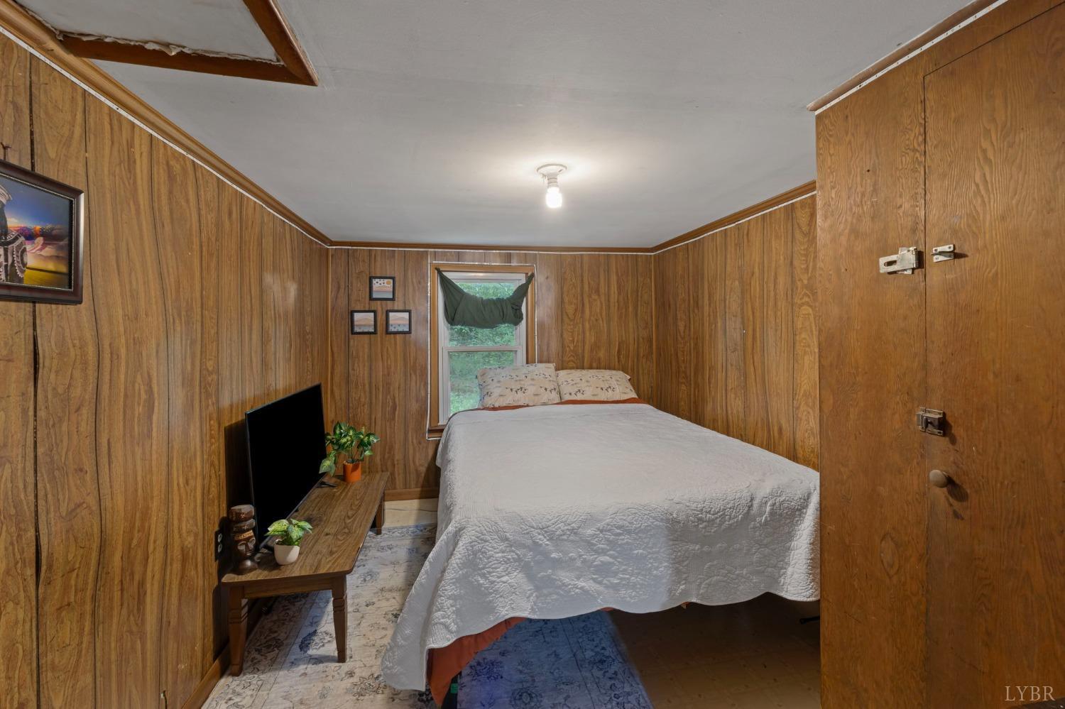 211 Shumaker Road Buckingham, VA 23921 - Photo 13 of 39 a bedroom with a bed and a flat screen tv