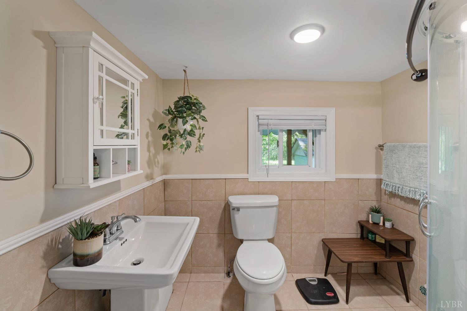 211 Shumaker Road Buckingham, VA 23921 - Photo 19 of 39 a bathroom with a toilet a sink and a window