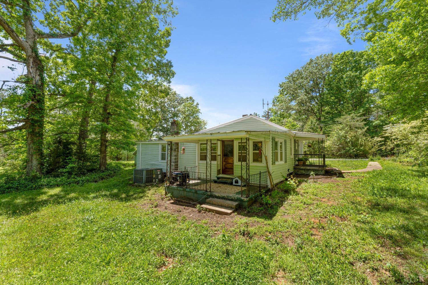 211 Shumaker Road Buckingham, VA 23921 - Photo 28 of 39 a backyard of a house with yard table and chairs