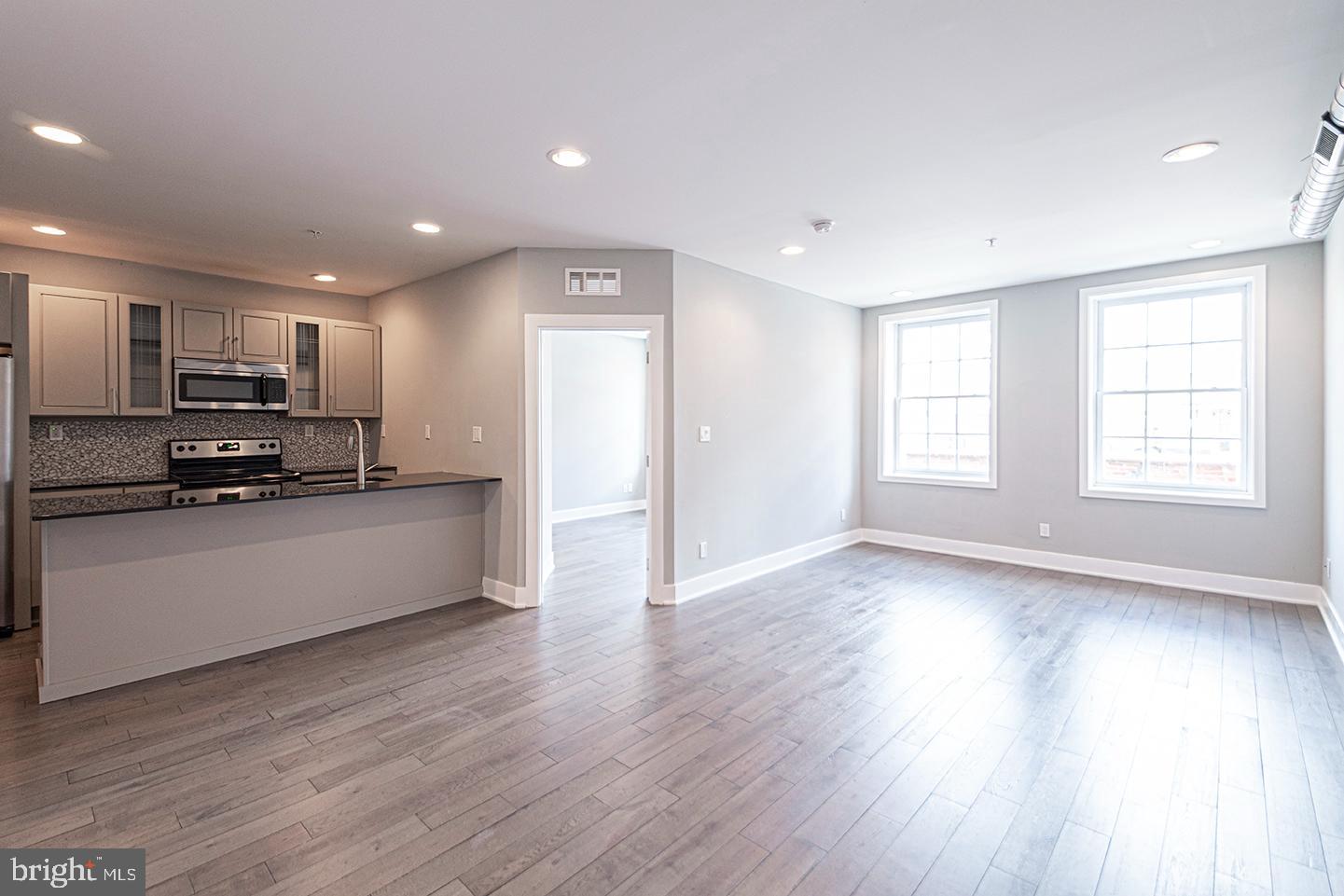 135 North 3rd Street, Unit 3D Philadelphia, PA 19106 - Photo 12 of 20 a view of kitchen with sink and wooden floor