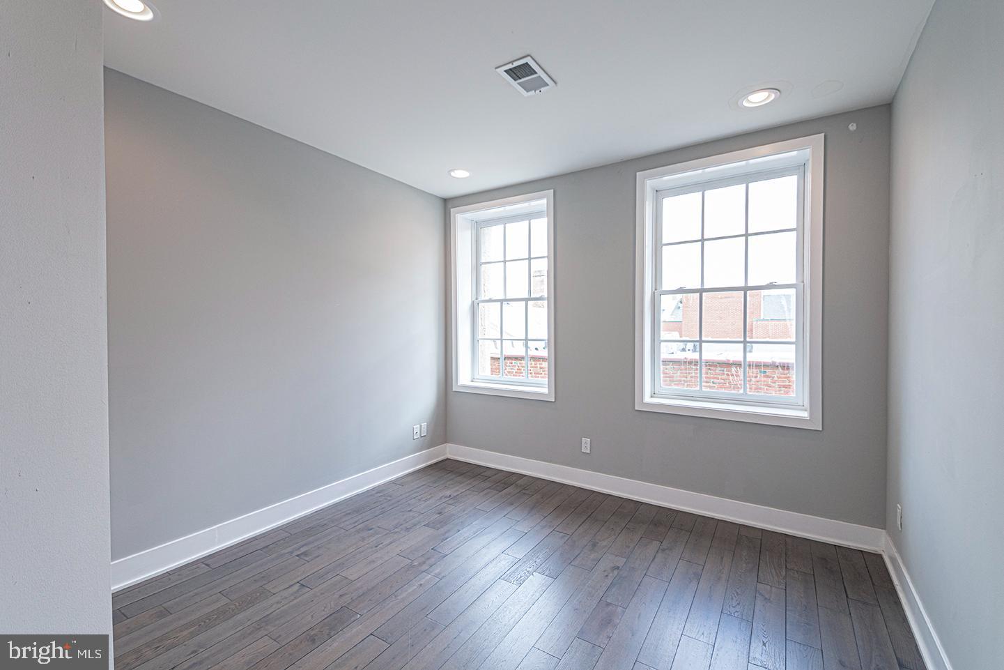135 North 3rd Street, Unit 3D Philadelphia, PA 19106 - Photo 13 of 20 an empty room with wooden floor and windows