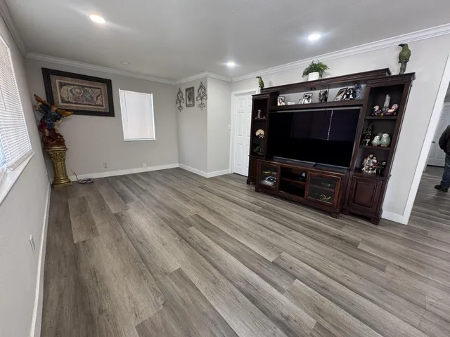 a view of livingroom with hardwood floor and a ceiling fan