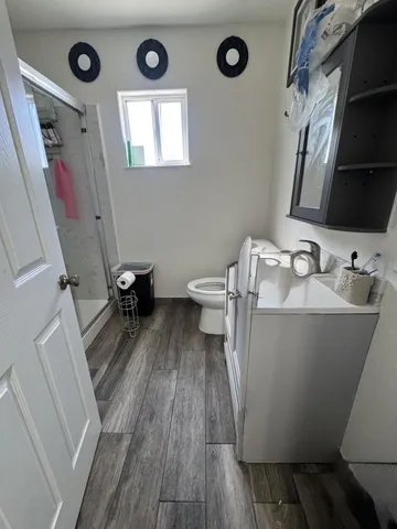 a bathroom with a sink mirror and toilet