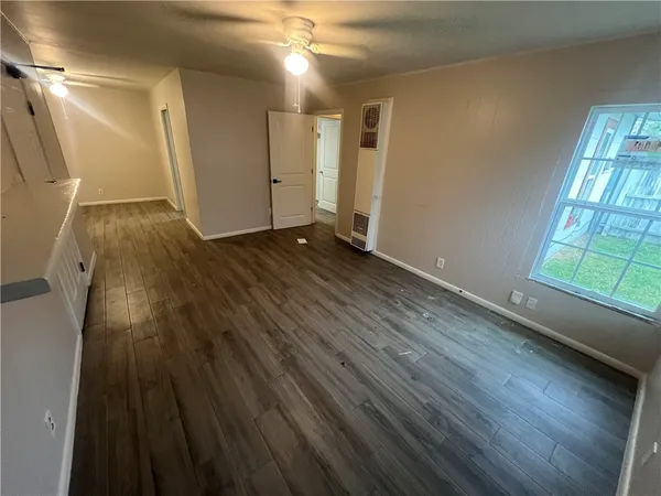 wooden floor in an empty room with a window