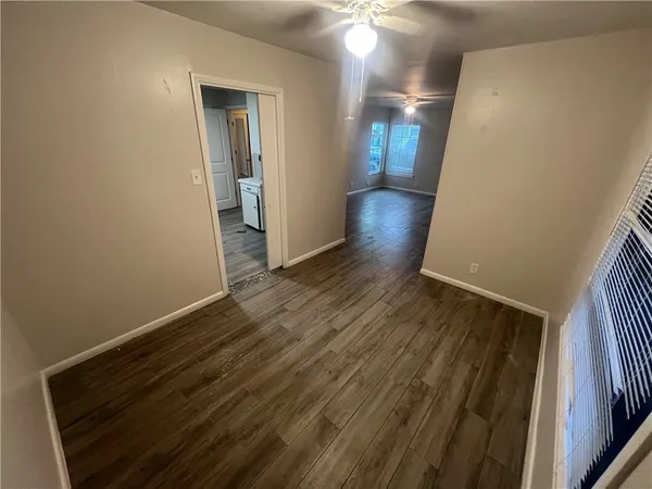 a view of hallway with wooden floor