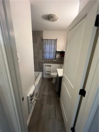 a bathroom with a sink a toilet a shower and a mirror