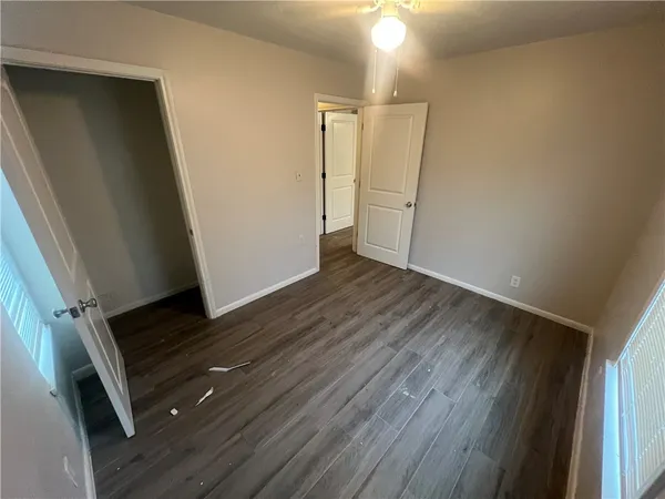 a view of an empty room with wooden floor