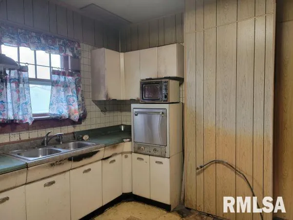 a kitchen with a sink cabinets and window