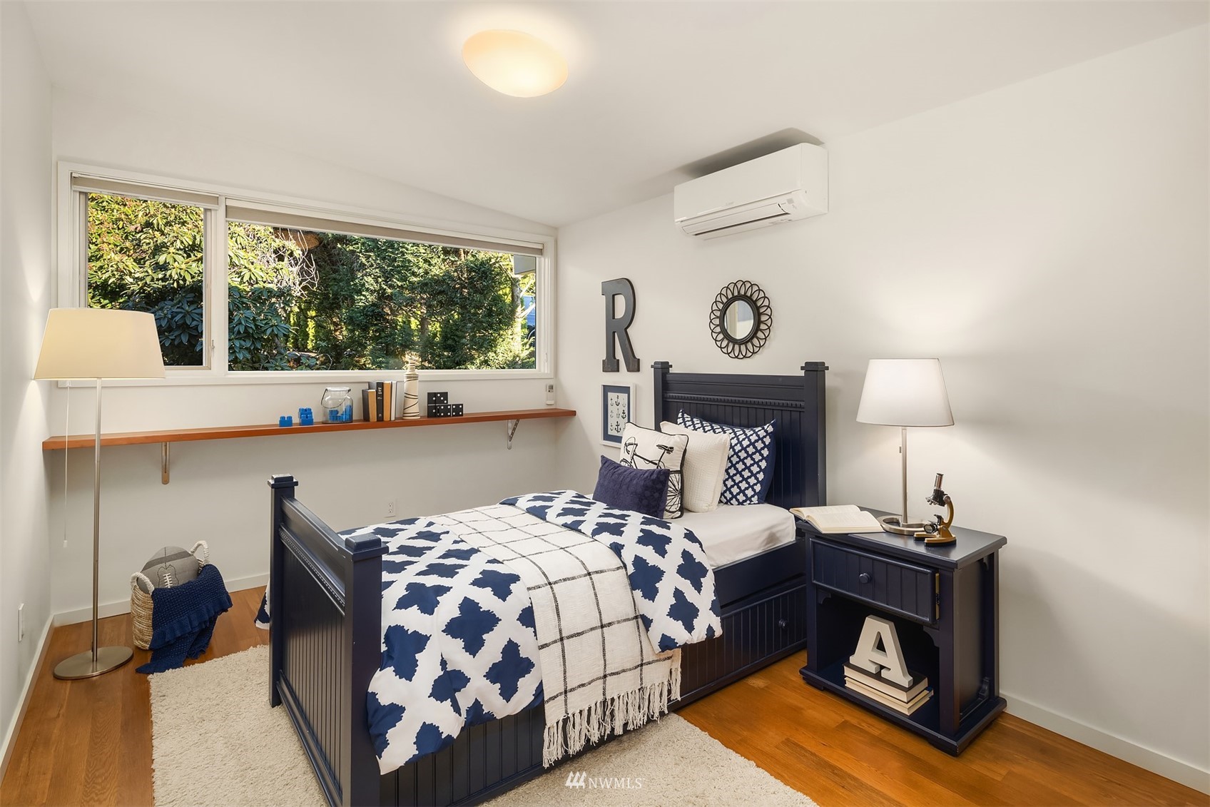 7255 West Ridge Road Mercer Island, WA 98040 - Photo 21 of 40 a bedroom with a bed and a lamp next to a large window