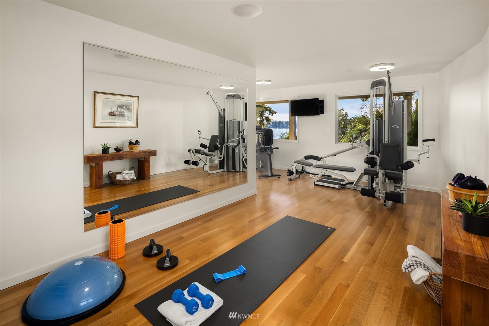 7255 West Ridge Road Mercer Island, WA 98040 - Photo 26 of 40 a room with wooden floor and gym equipment