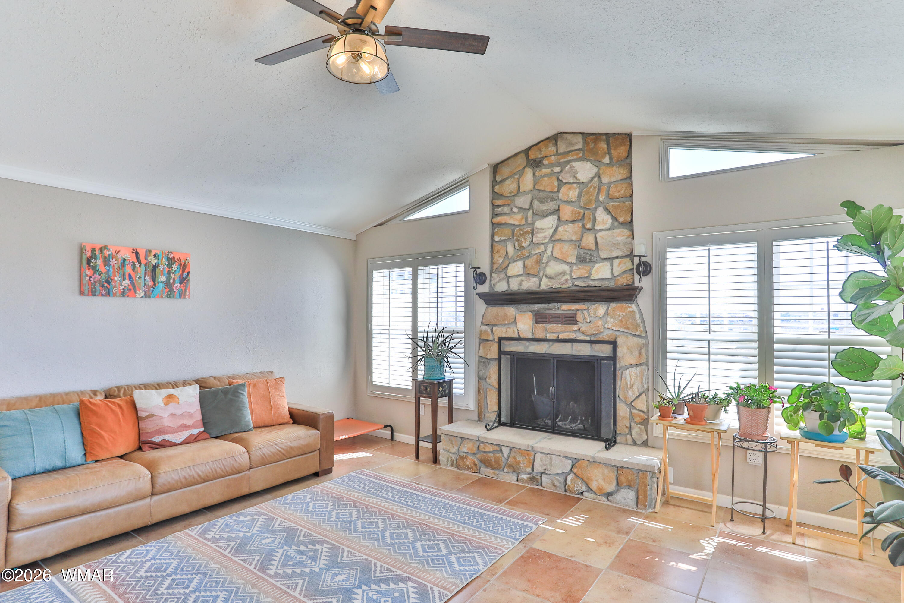 102 Crestview Road Holbrook, AZ 86025 - Photo 6 of 55 a living room with furniture a chandelier and a fireplace