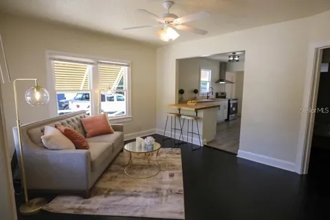 a living room with furniture and a wooden floor